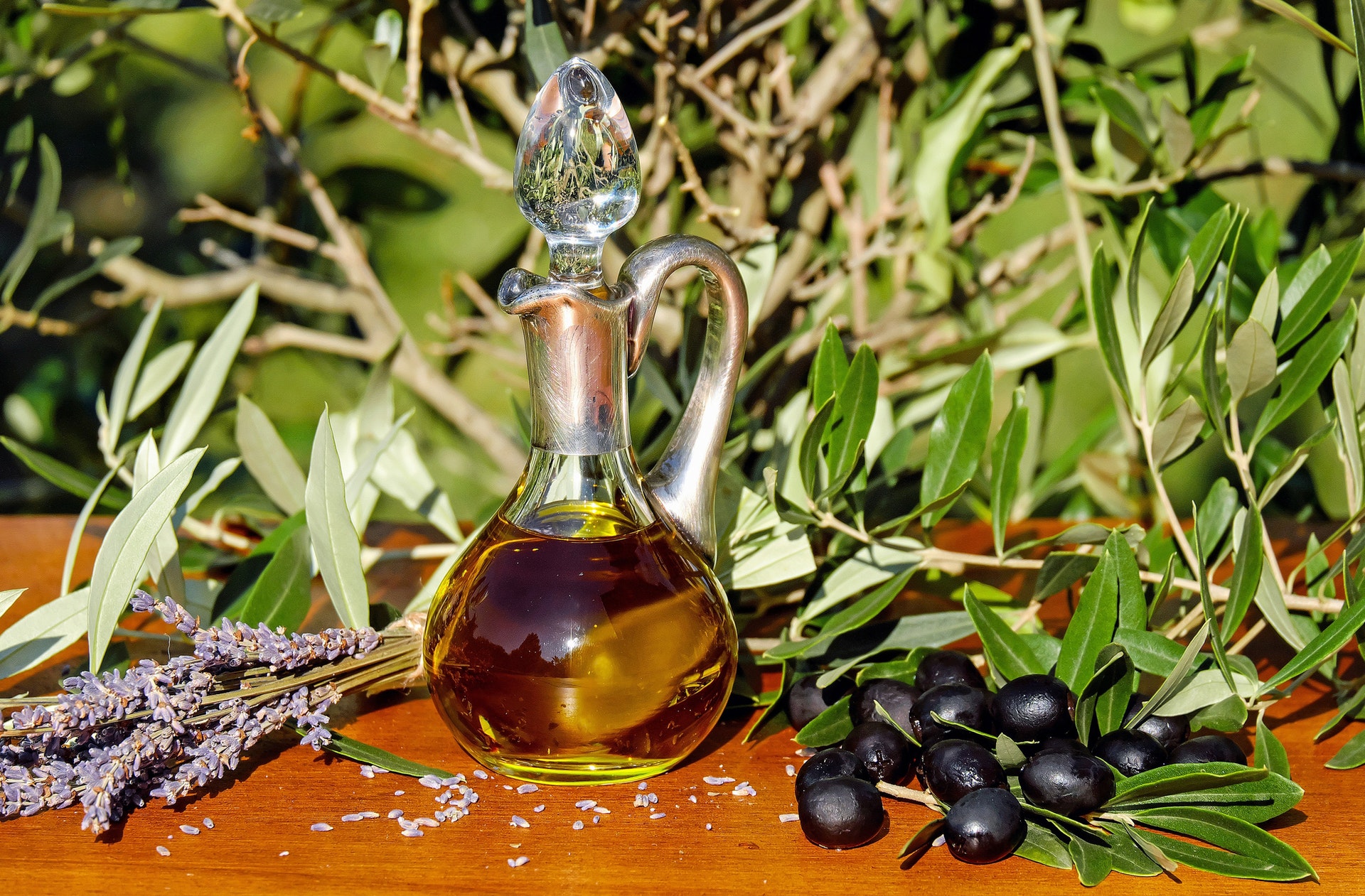 Black olives, lavender leaves, and a jar of olive oil
