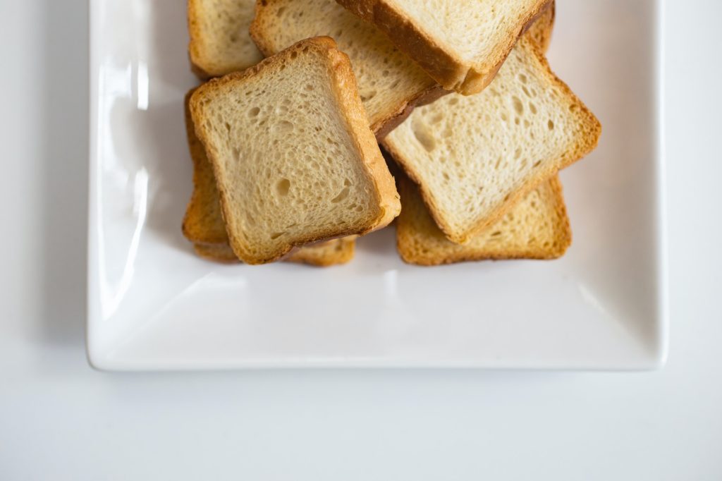 Slices of white toast on  a white plate