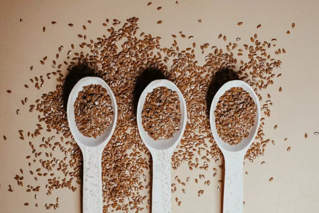 3 wooden spoons with flaxseeds