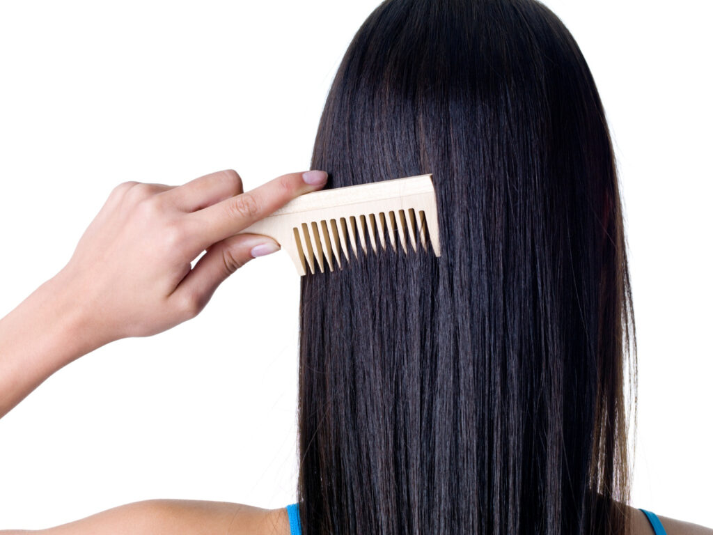 A woman combing her long straight hair