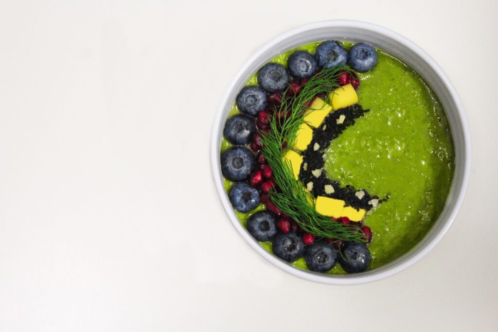 Green Shake With Blueberries in White Bowl
