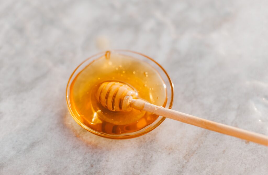 Honey and spoon in a small bowl