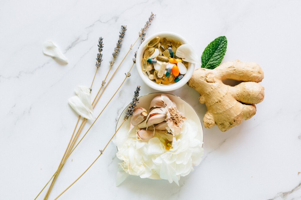 Garlic, ginger, supplements, and lavender on a white background