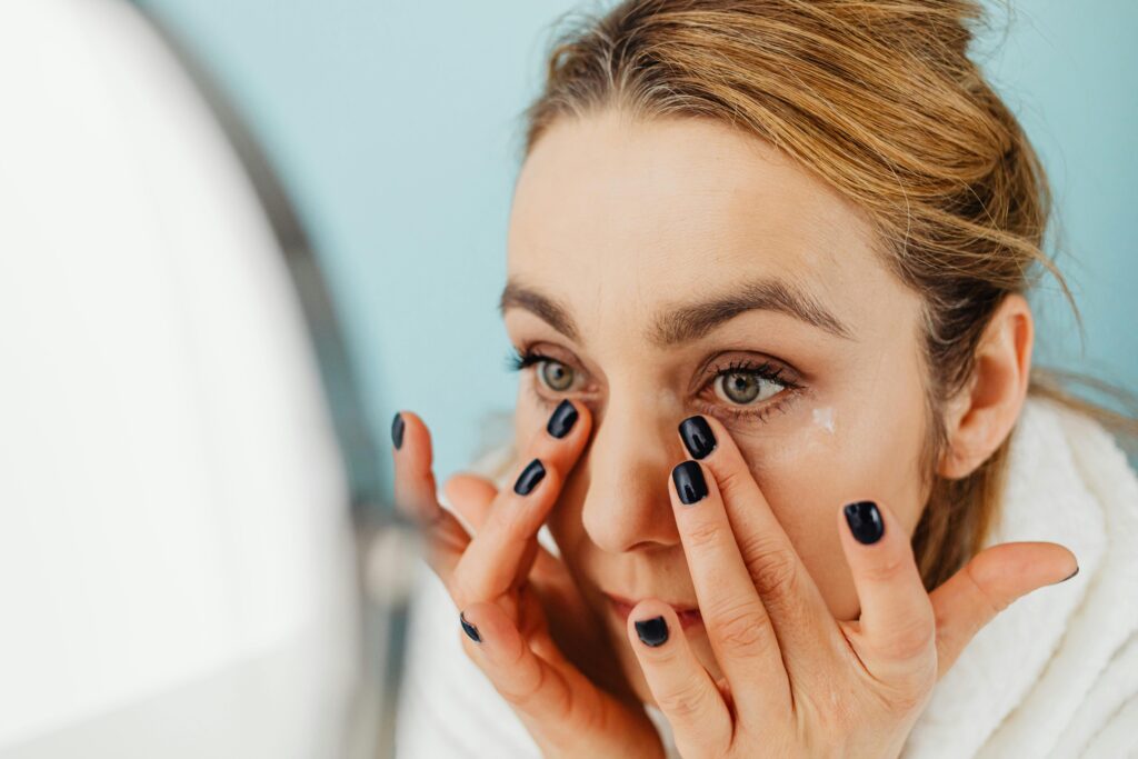 Woman applying an eye cream