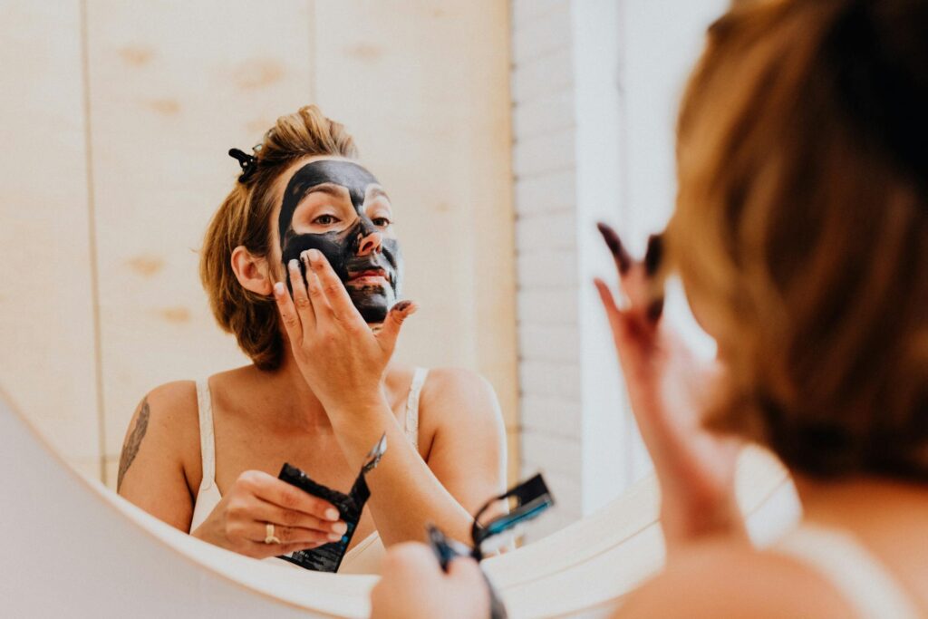 Woman applying an exfoliator to her face